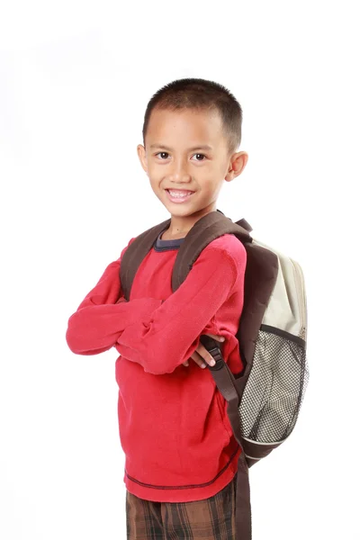 Portrait of boy with backpack smiling against white — Stock Photo, Image