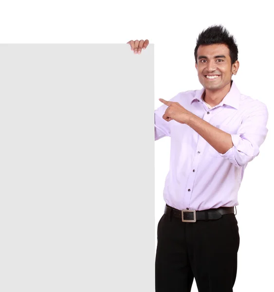Businessman holding a blank sign in front of him — Stock Photo, Image