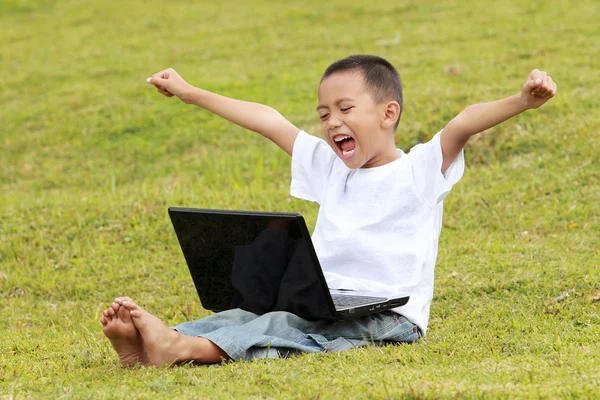 Kleiner Junge feiert Erfolg beim Laptop spielen — Stockfoto