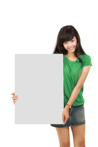 Beautiful woman holding empty white board — Stok fotoğraf