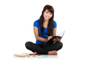 Girl writing at note pad, white background clipart