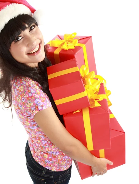 Christmas woman holding gifts wearing Santa hat — Zdjęcie stockowe