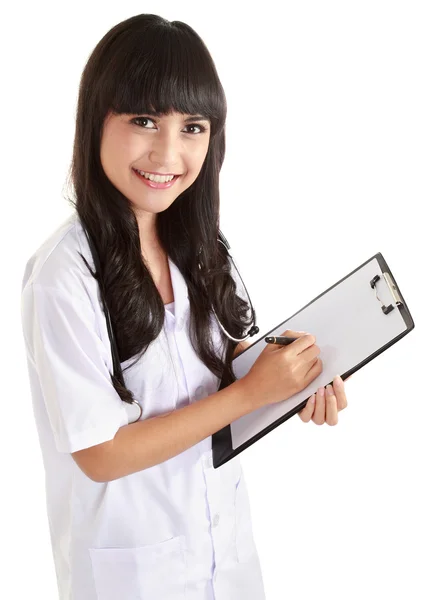 Female doctor writing on clipboard — Stock Photo, Image