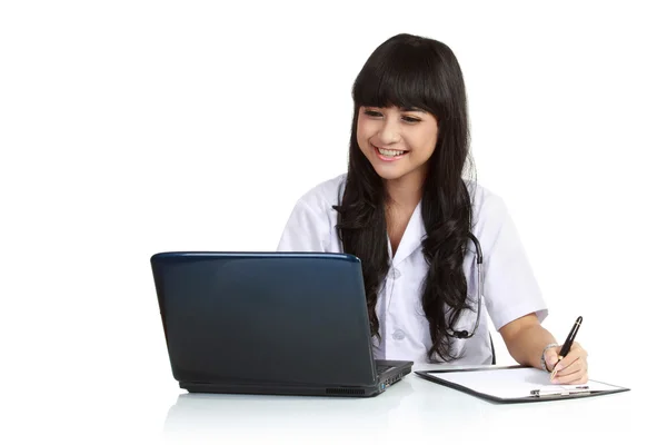 Donna medico scrivere un appunti con un computer portatile — Foto Stock