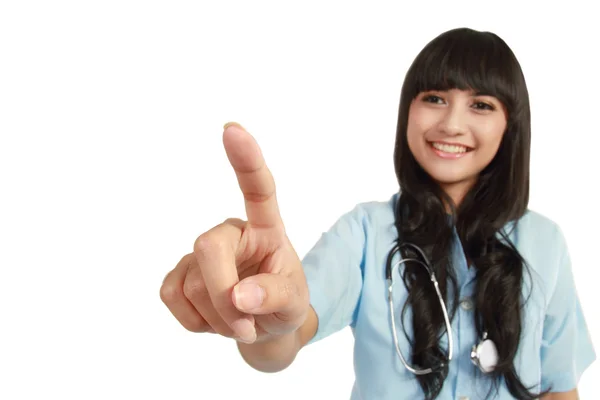 Jonge verpleegster wijzend op copyspace — Stockfoto