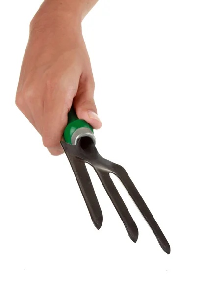 Mão segura um garfo para jardinar — Fotografia de Stock