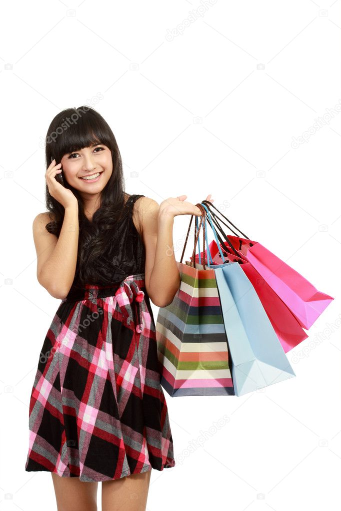 Shopping woman with bags talking on the phone