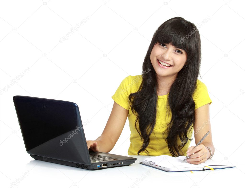 Girl with laptop and write on a books