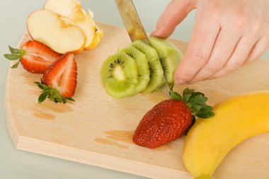 Fruits on chopping board clipart