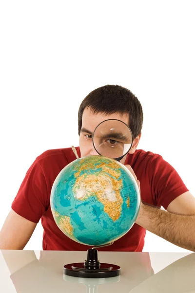 Man looking at globe — Stock Photo, Image