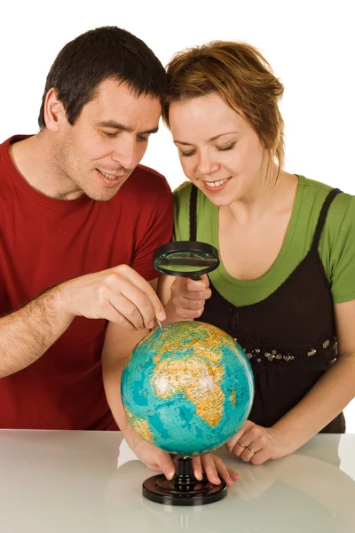 stock image Couple looking at globe