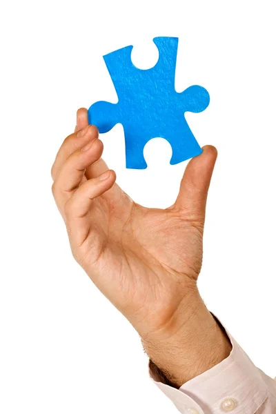 stock image Businessman holding a piece of puzzle