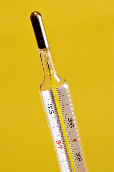 Thermometer on yellow — Stock Photo, Image