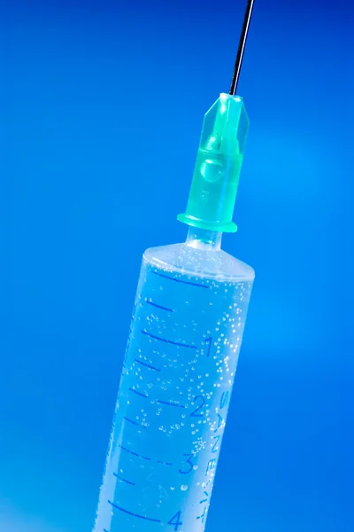 Syringe on blue — Stock Photo, Image