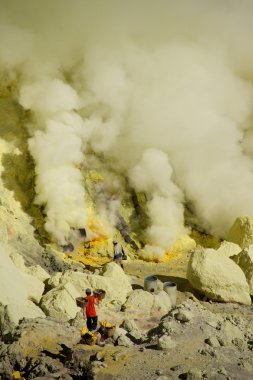 Workers mining sulfur inside volcano Ijen clipart