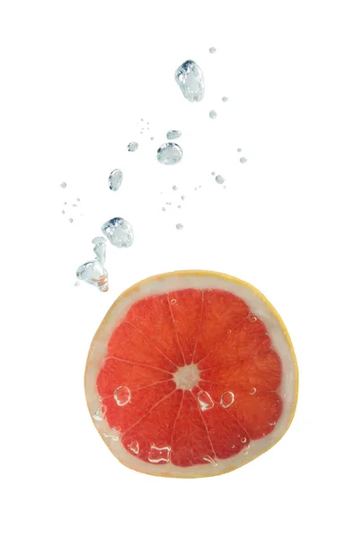 Grapefruit in water with air bubbles — Stock Photo, Image