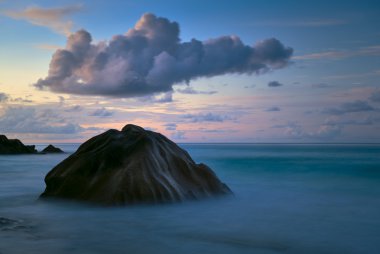 Stone, the cloud and in the evening the sea clipart