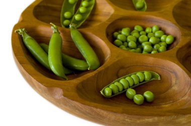 Fresh green peas in wooden bowl clipart