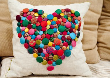 Cushion embellished with colourful buttons clipart