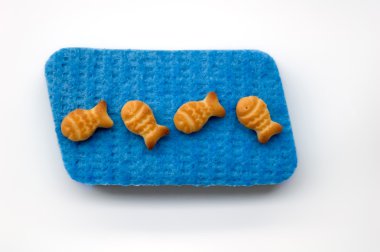 Fish crackers on blue sponge clipart