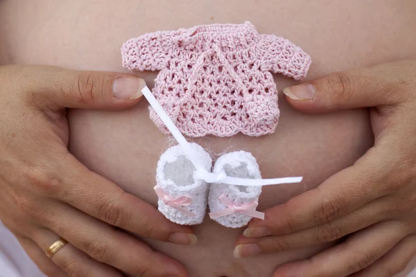 stock image Pregnant woman with socks and jacket