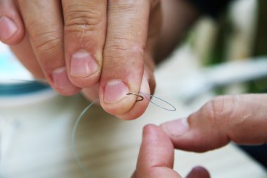 Man Tying A Hook clipart