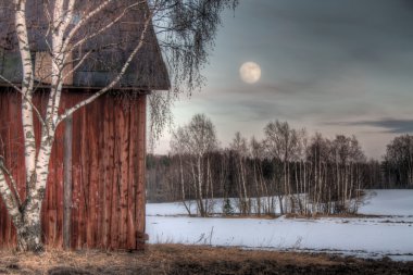 Old red barn in a countryside landscape clipart