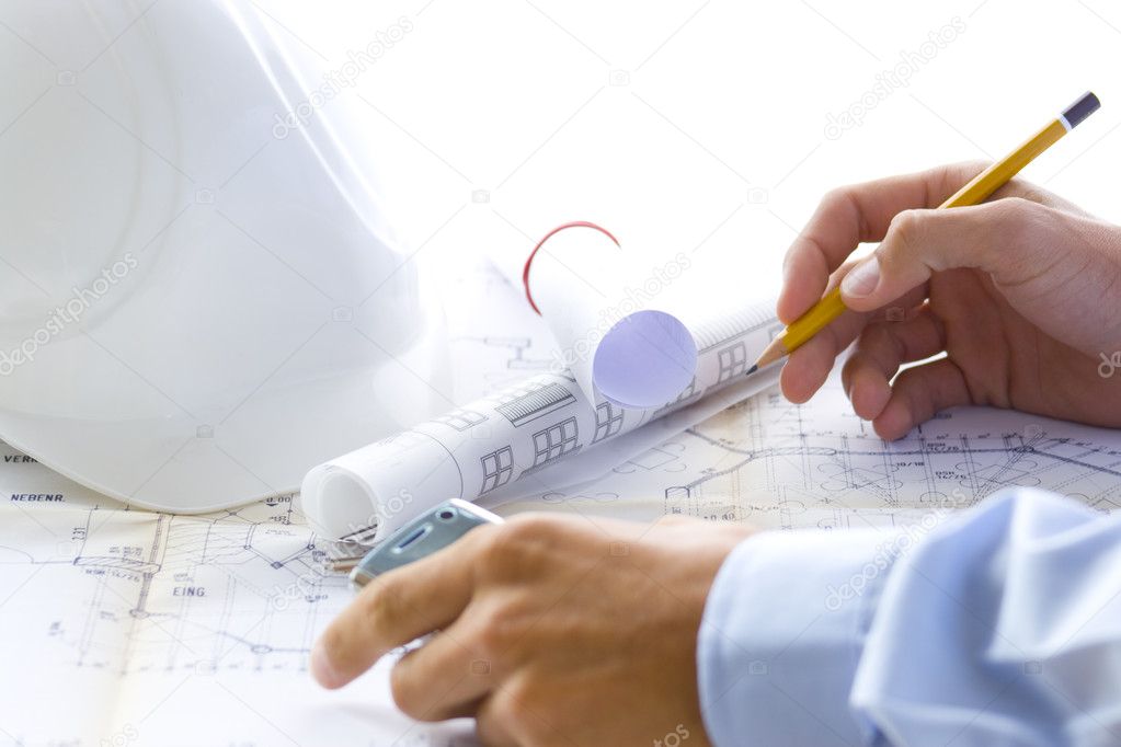 Architect at work with his plan
