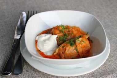 Stuffed cabbage with tomato sauce clipart