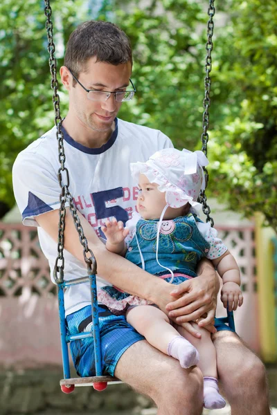 A father and baby on the swing — Stock Photo, Image