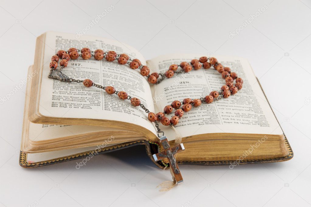 Old hymnal and a rosary
