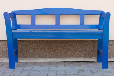 Blue bench in front of a house clipart