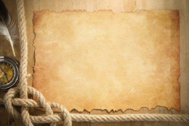 Ship ropes and compass at parchment old paper clipart