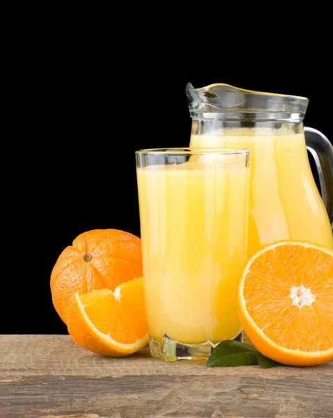 Zumo de naranja en vaso y rebanadas aisladas en negro —  Fotos de Stock