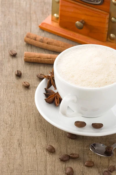 Xícara de café com grãos e moedor — Fotografia de Stock