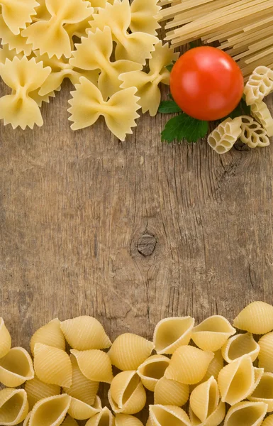 Raw pasta at wood background — Stock Photo, Image