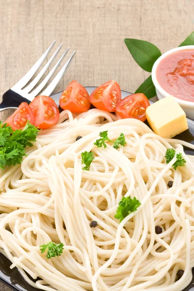 Spaghetti food and vegetables spices on wood — Stock Photo, Image