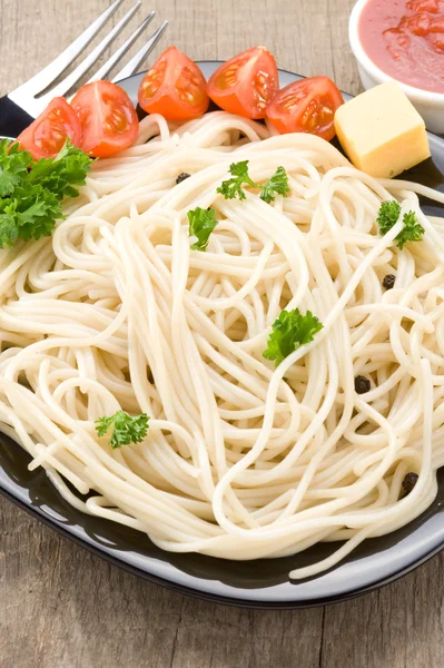 Pasta in plate on wood — Stock Photo, Image