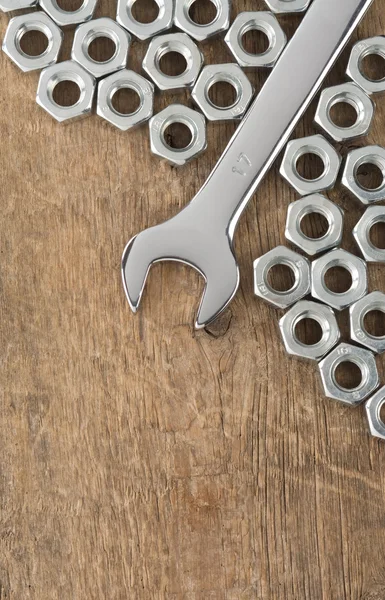 Wrench and nut tool on wood — Stock Photo, Image