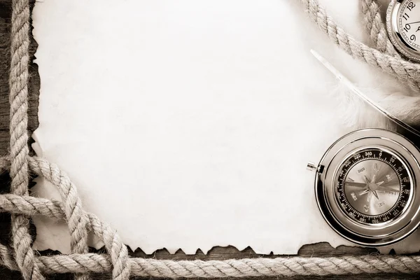 Ropes and compass on old grunge old paper — Stock Photo, Image