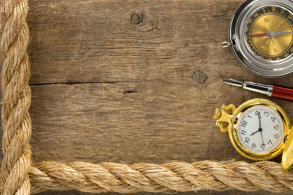Судовые веревки и компас с ручкой на дереве — стоковое фото