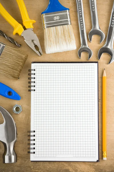 Tools and pad on wood — Stock Photo, Image