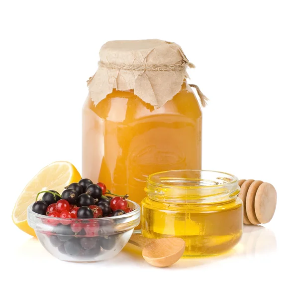 Glass jar full of honey, lemon and berry — Stock Photo, Image