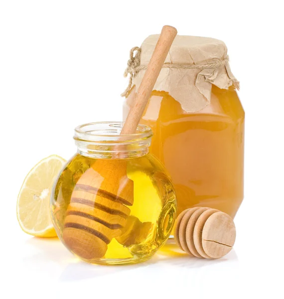 Skleněné nádoby plné medu a citronu — Stock fotografie