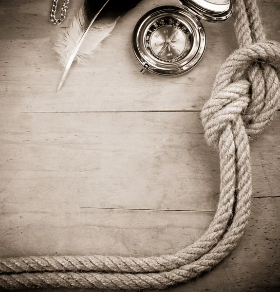 Ship ropes and compass on wood — Stock Photo, Image