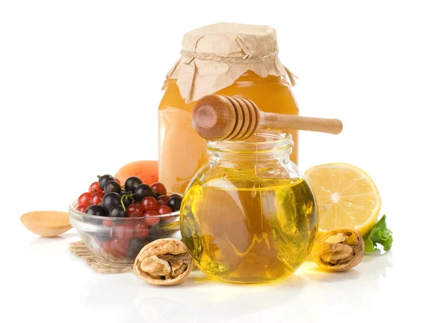 Glasburk full av honung, citron och berry — Stockfoto