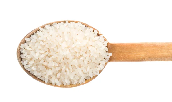 Grão de arroz em colher de madeira — Fotografia de Stock