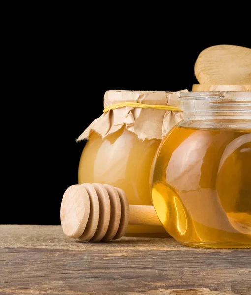 Jar full of honey and stick — Stock Photo, Image