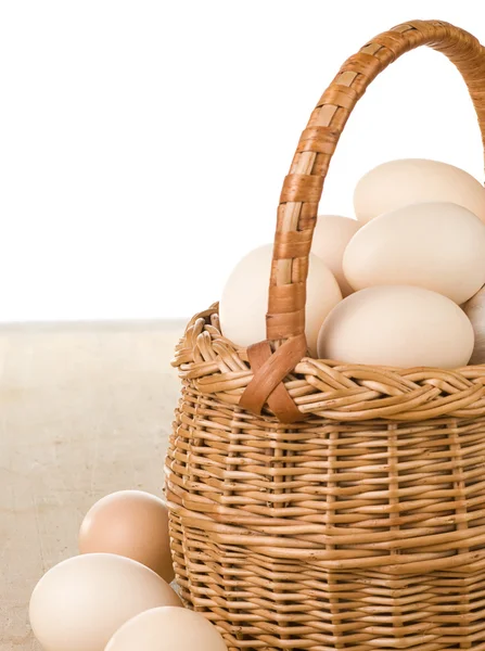 Eggs and basket isolated on white — Zdjęcie stockowe