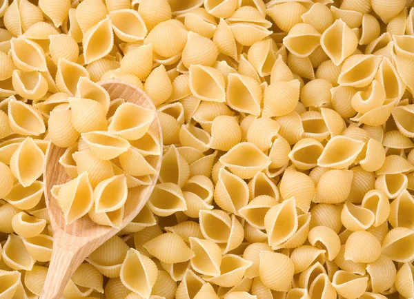 Pasta and wooden spoon — Stock Photo, Image